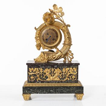 A presumably French Empire-style gilt bronze and marble mantel clock, later part 19th century.