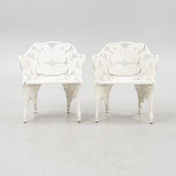 A painted pair of cast aluminum garden armchairs and a table, second part of the 20th Century.