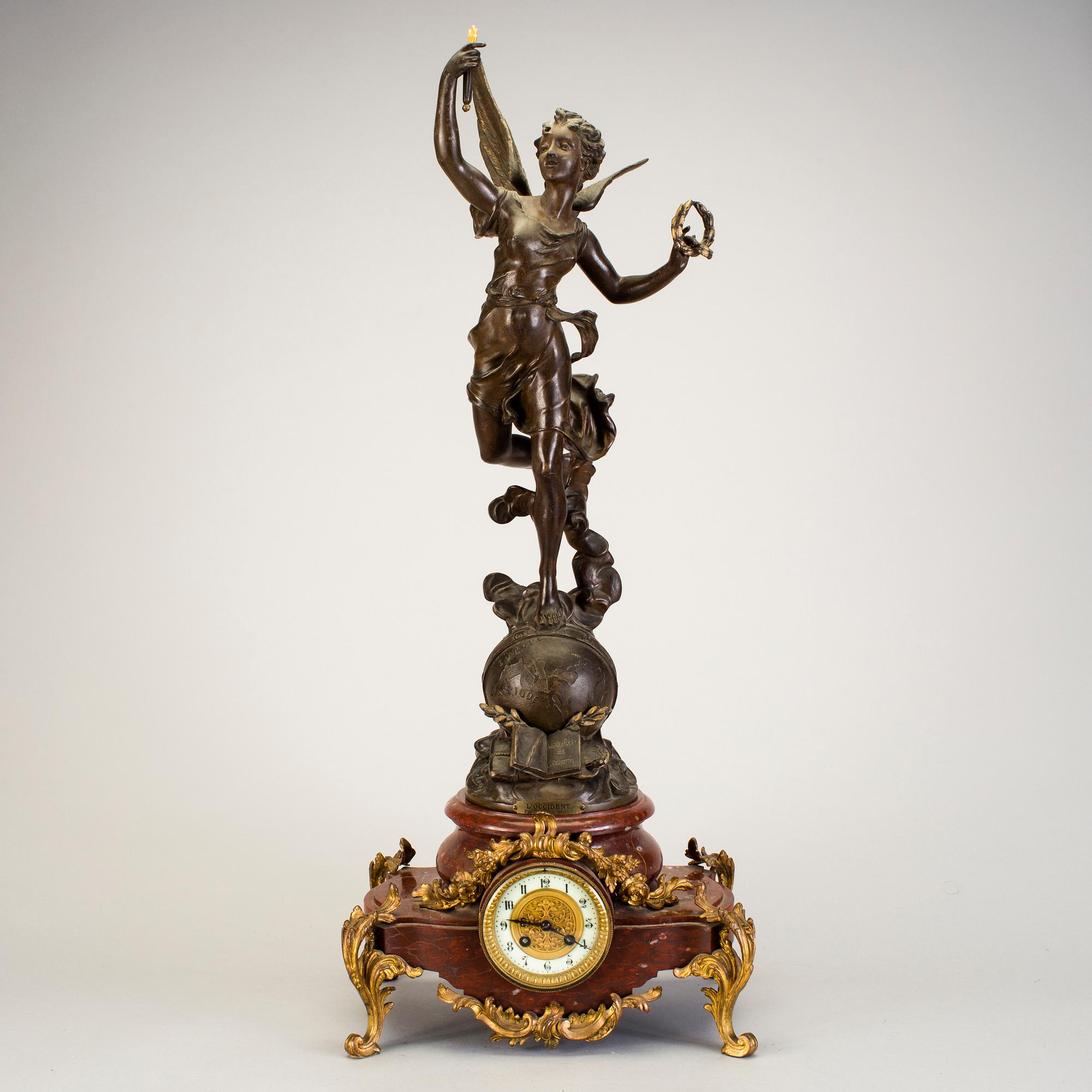 A mantel clock with sculpture "L'occident" after Émile Bruchon from the turn of the century 1800/1900.