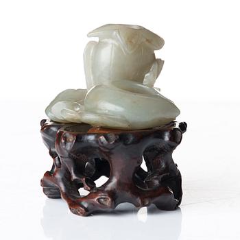 A sculptured nephrite belt buckle, figurine and brush washer, late Qing dynasty.