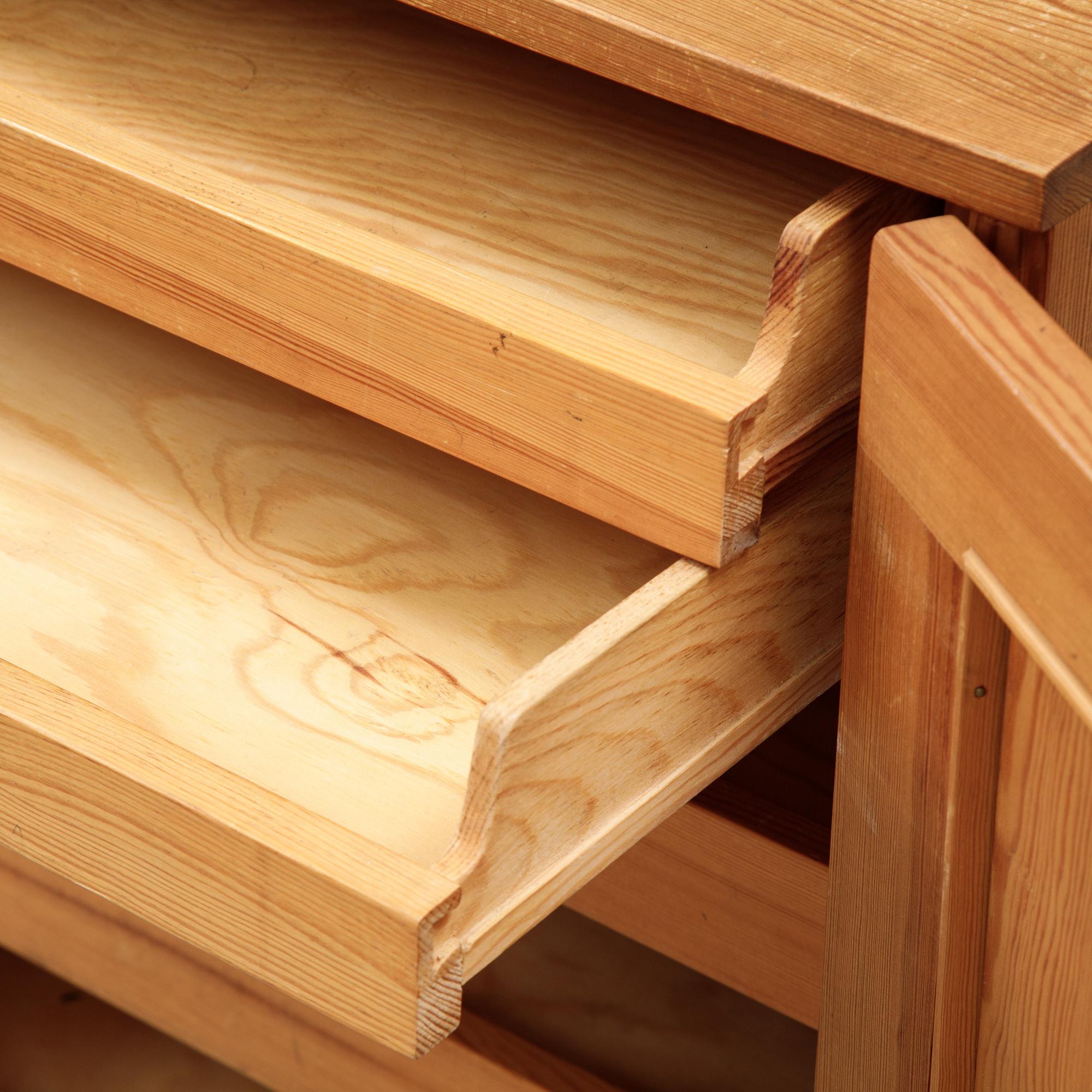 A pair of pine cupboards with shelves by Carl Malmsten.