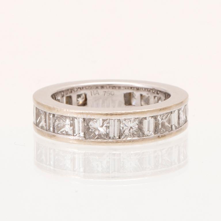 An 18K white gold eternity ring set with baguette and princess cut diamonds by Hartmann's Denmark.