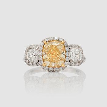 1192. A fancy yellow cushion-cut diamond, 2.57 cts, FY/VS2, ring.