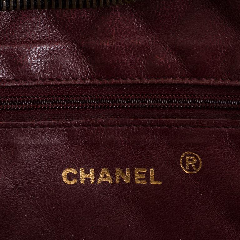 a CHANEL black leather bag.