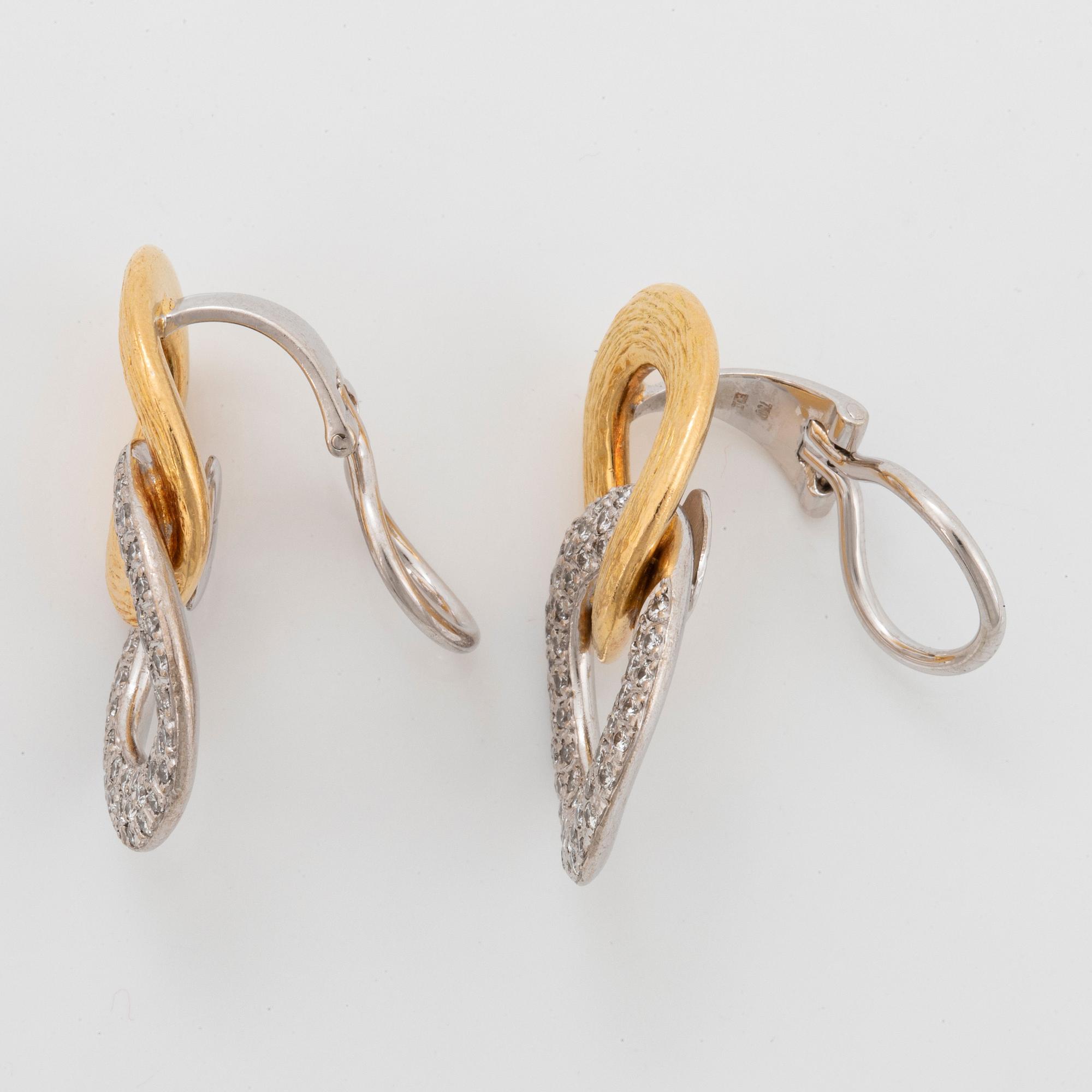A pair of 18K gold and white gold Meister earrings set with round brilliant-cut diamonds.