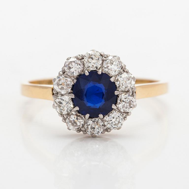 An 18K gold ring, with a sapphire and old-cut diamonds.