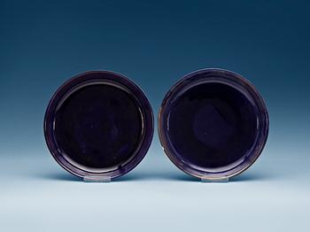 1407. A pair of large aubergine glazed dishes, Qing dynasty with Kangxi six character mark and of the period (1662-1722).