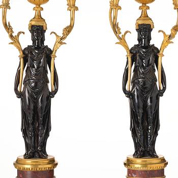 A pair of Louis XVI ormolu and patinated bronze six-branch candelabra attributed to François Rémond, late 18th century.