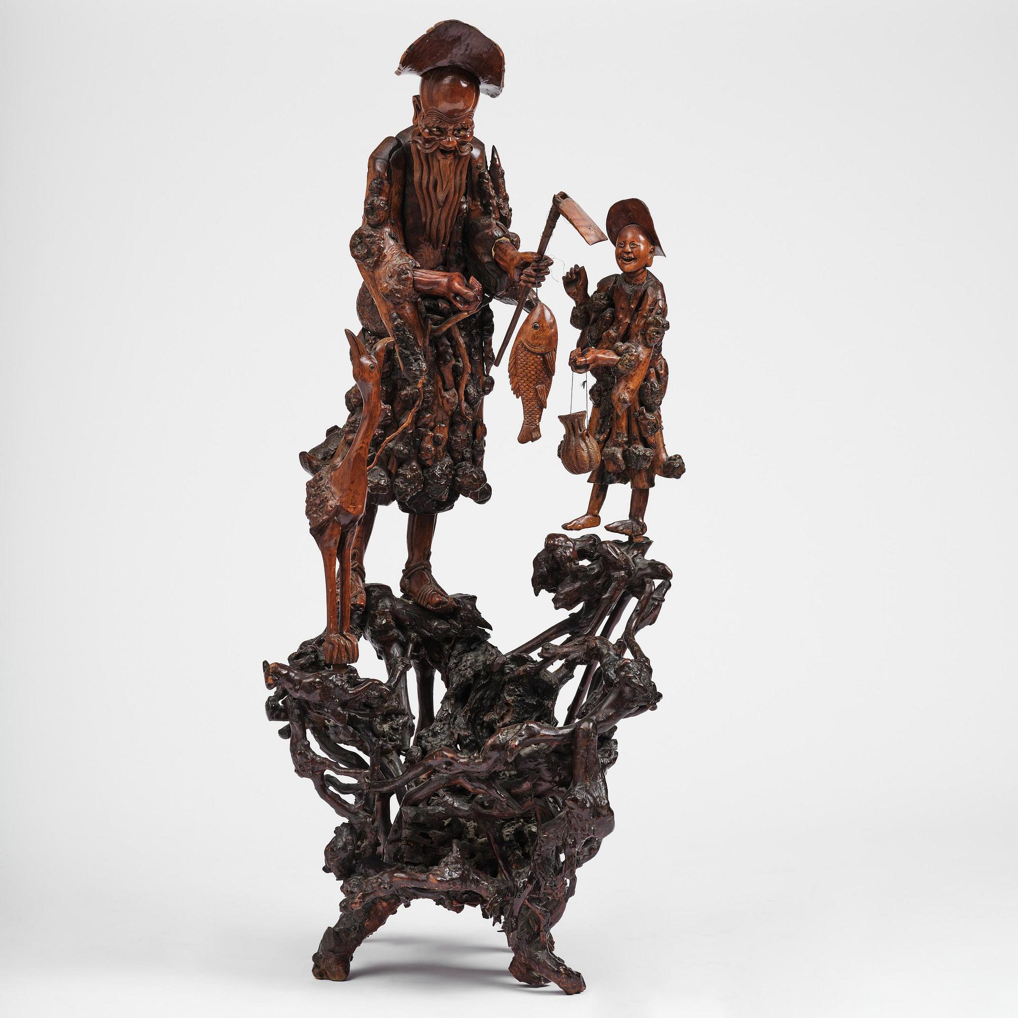 A large well sculptured root sculpture of 'Sholau and attendant', late Qing dynasty, 19th century.