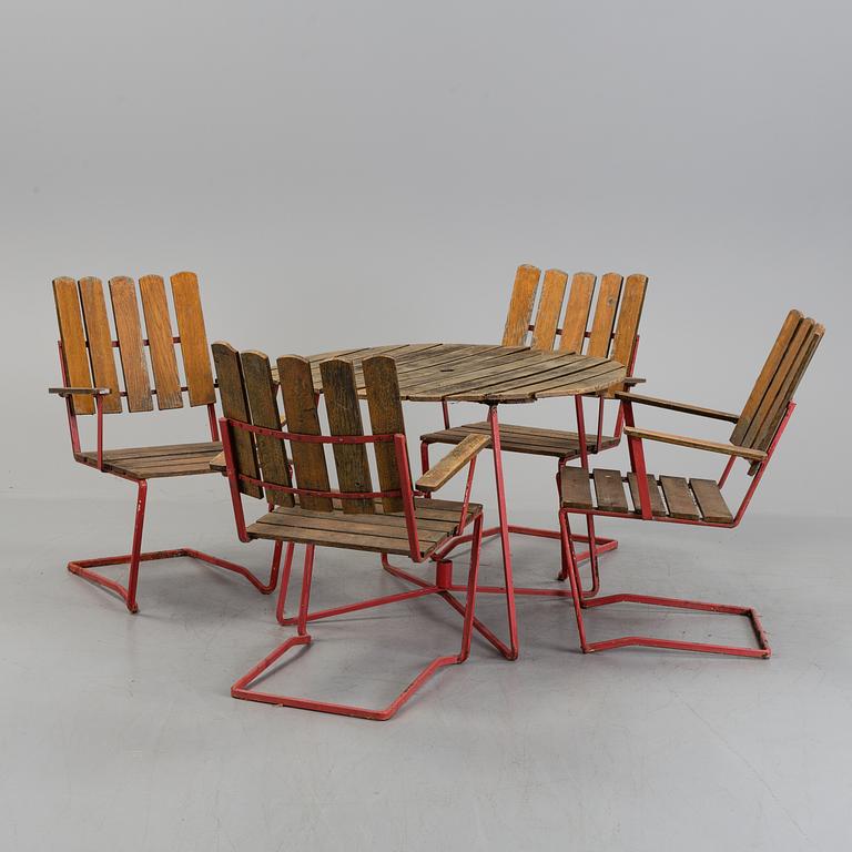 A garden table and four chairs, 20th century.