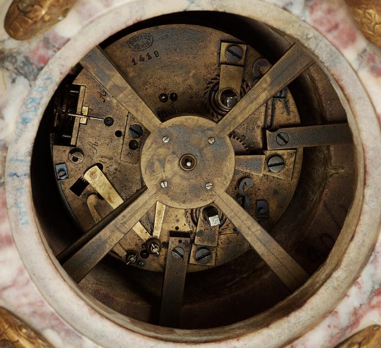 A Louis XVI-style late 19th century gilt bronze and marble vase clock "Pendule à cercles tournants", Dufaud Paris.