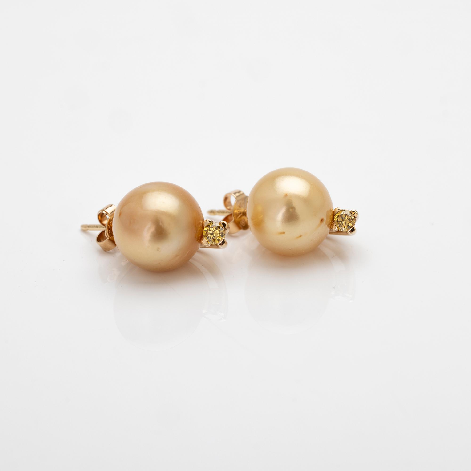 18K gold earrings with South Sea pearls and diamonds.