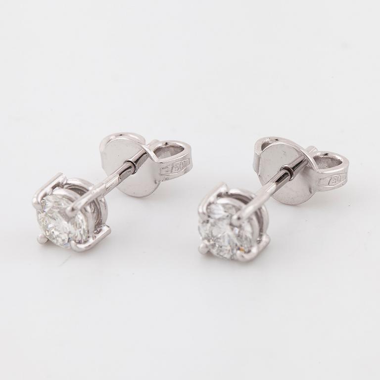 A pair of brilliant cut diamond earrings.