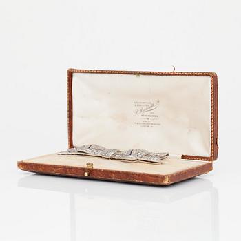 A circa 1920's bow brooch set with sapphires and old-cut diamonds.