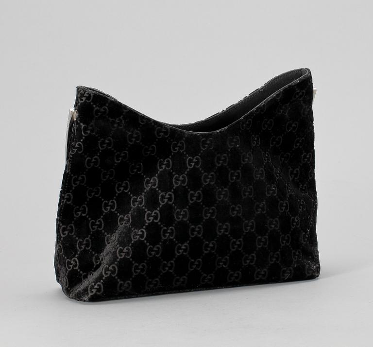 A black monogram suede handbag by Gucci, fall/winter 1997, The Tom Ford collection.