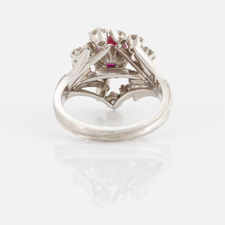 A WA Bolin ring set with a faceted pink sapphire and round brilliant- and navette-cut diamonds.