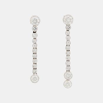 394. A pair of 18K white gold earrings set with round brilliant-cut diamonds.