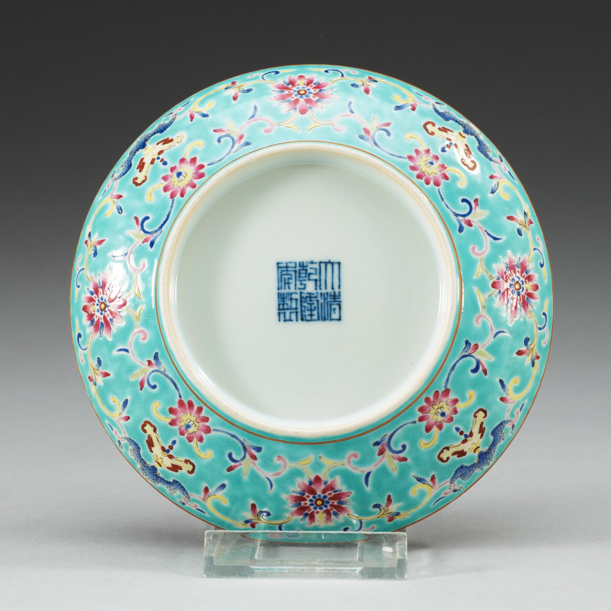 A turkoise ground famille rose dish, Qing dynasty, with Qianlongs seal mark.