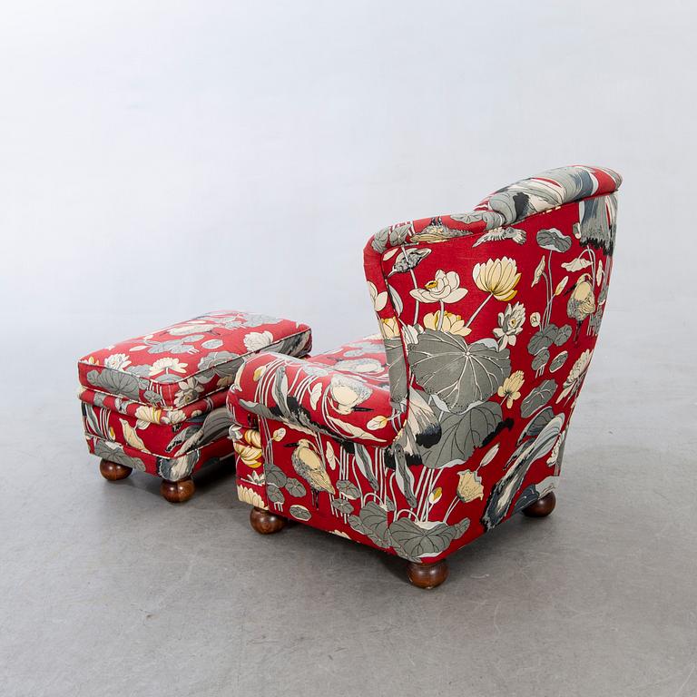 An easy chair with stool later part of the 20th century.