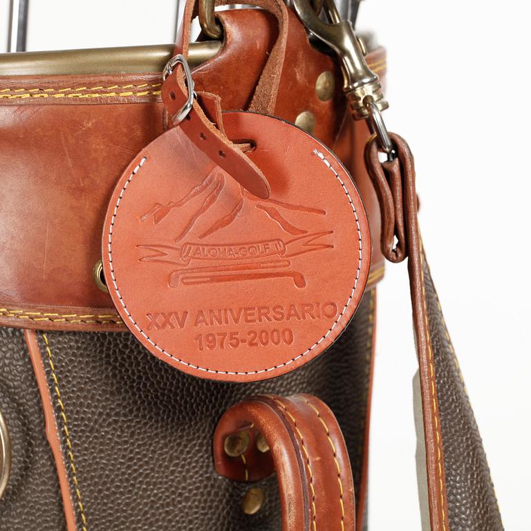 MULBERRY, a green leather golf bag with golf clubs.