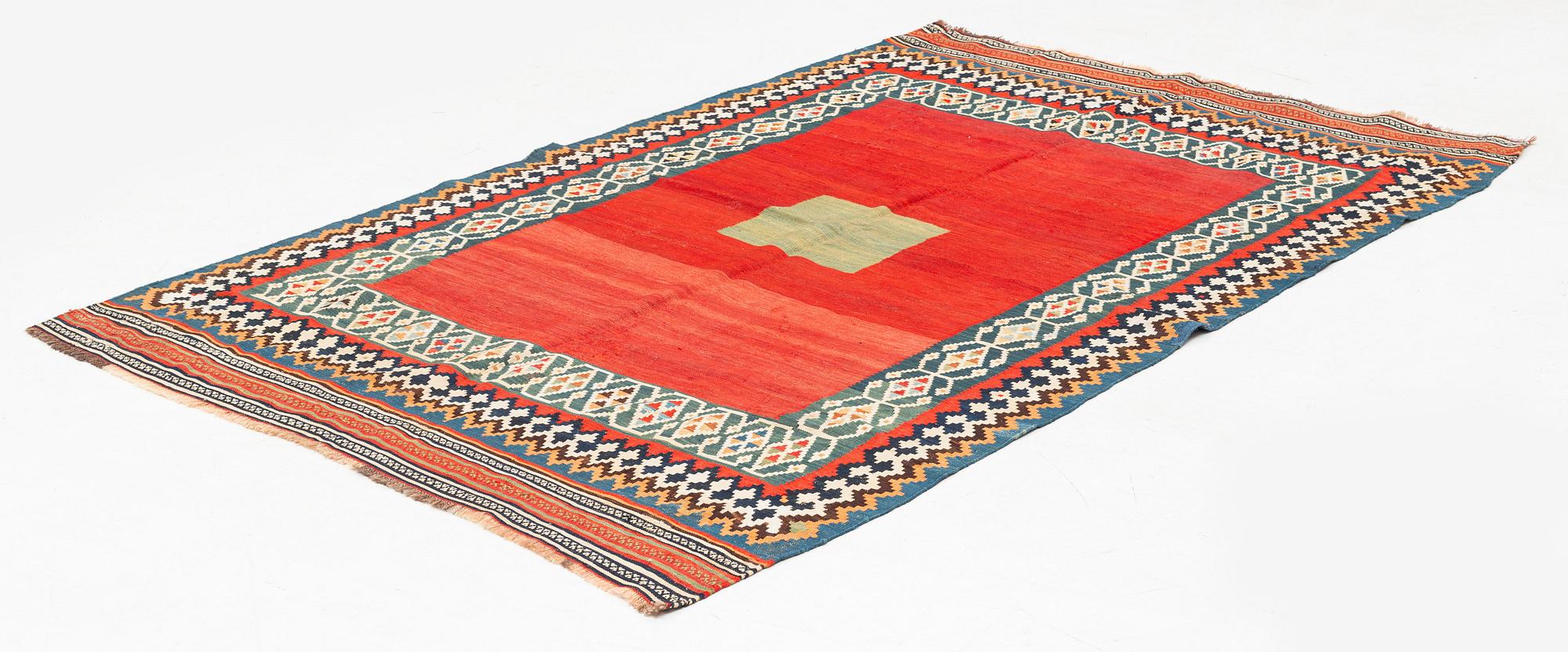 An antique Qashqai kilim rug, approximately 240 x 155 cm.