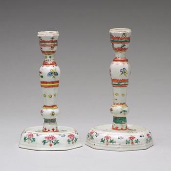 A pair of famille rose candle sticks, Qing dynasty, Qianlong (1736-95).