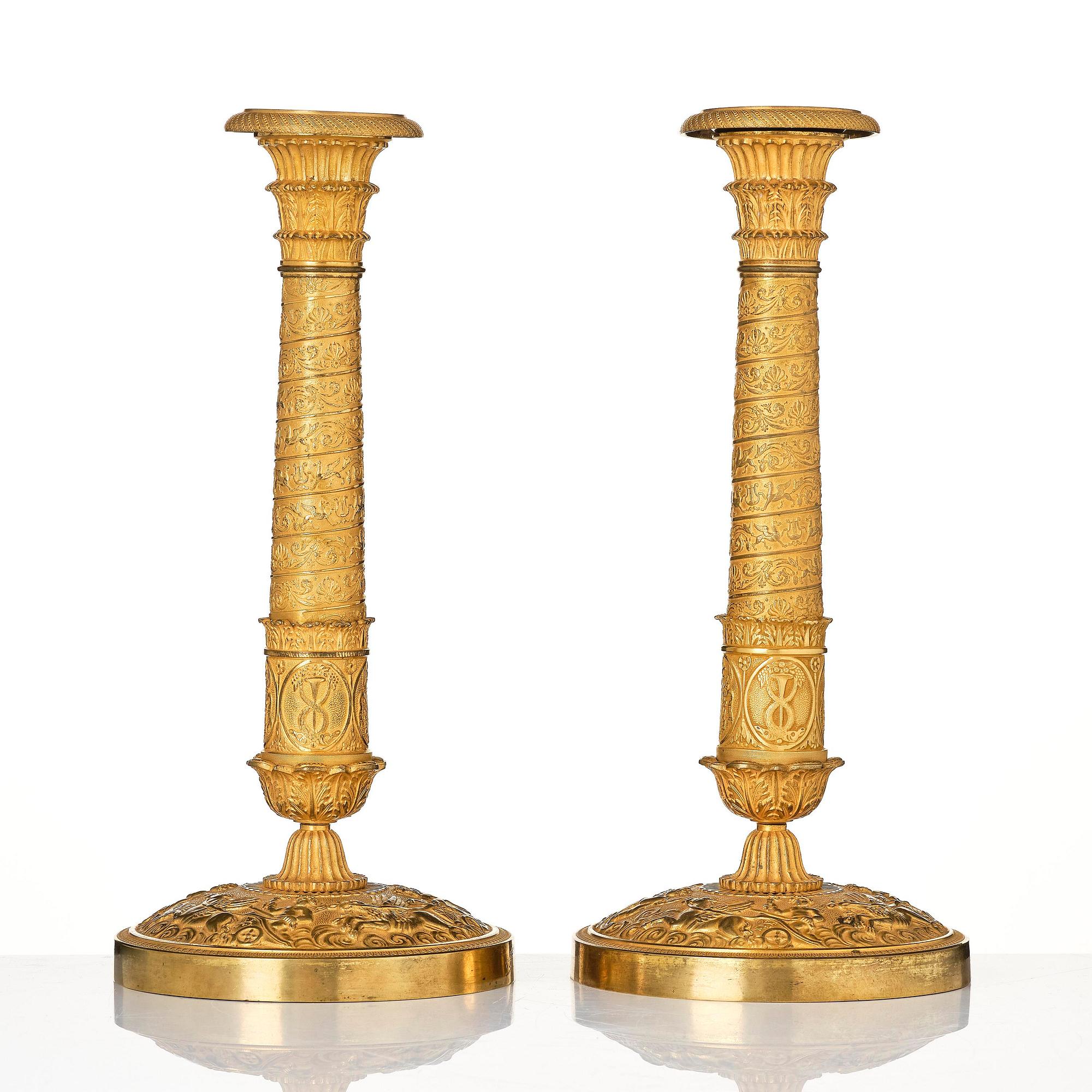 A pair of French Empire ormolu candlesticks, Paris, early 19th century.