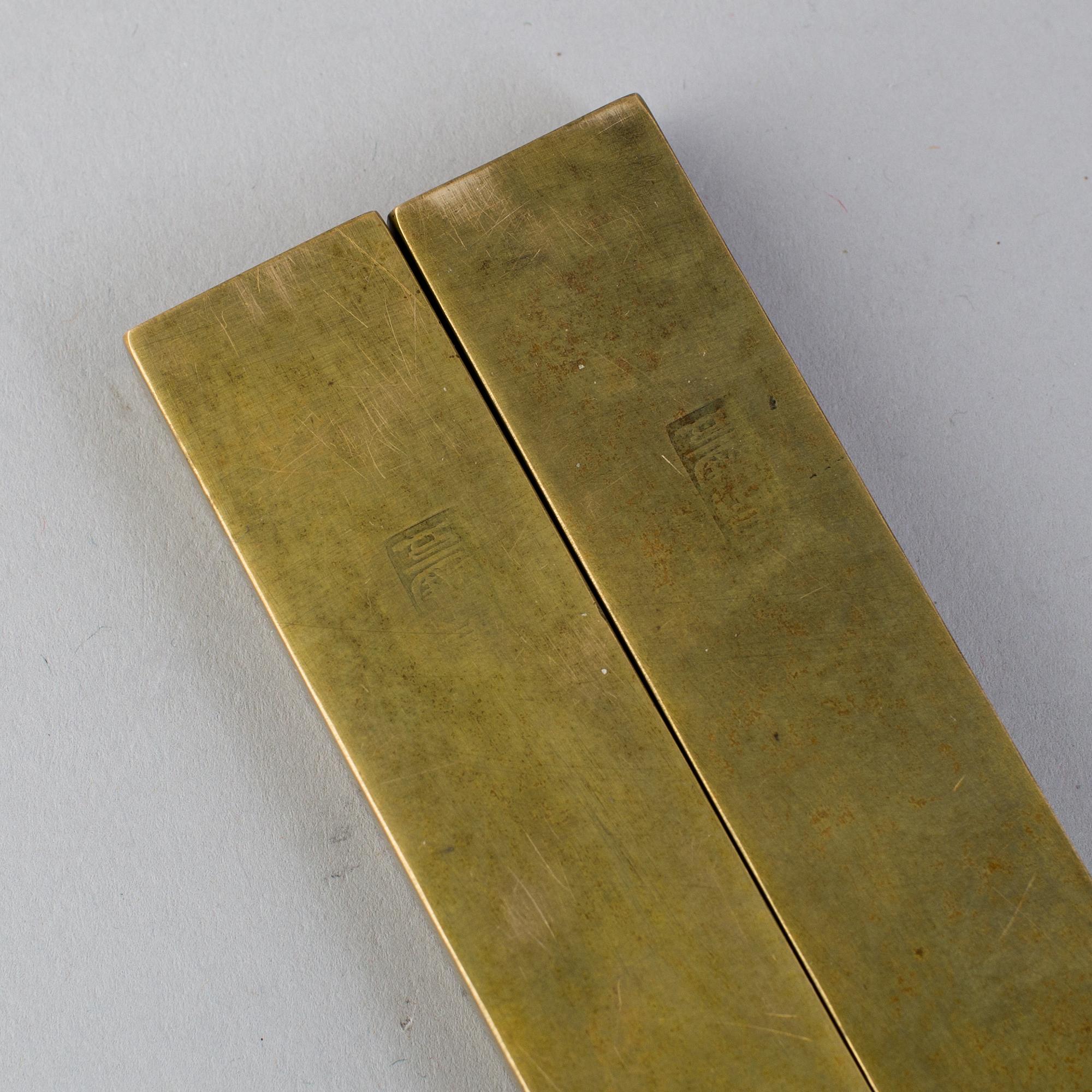 A pair of Japanese scroll weights, early 20th Century.