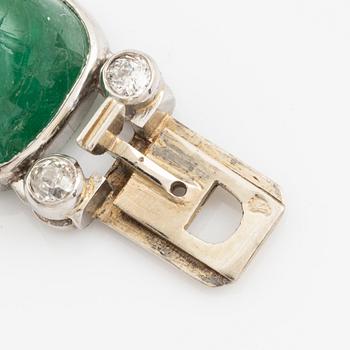 An art deco platinum necklace/bracelet combination with cabochon-cut emeralds.