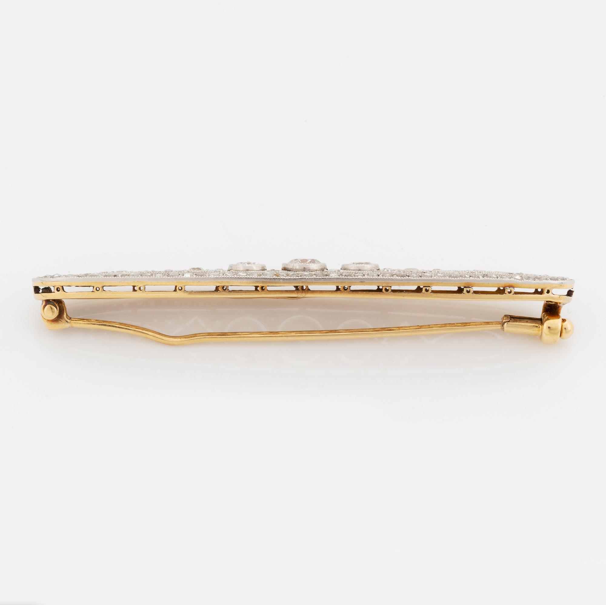 A platinum and 18K gold brooch set with old- and rose-cut diamonds.