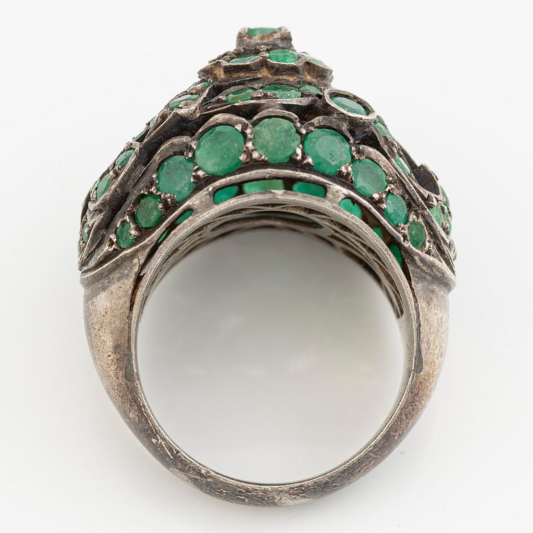 Silver ring with green stones.
