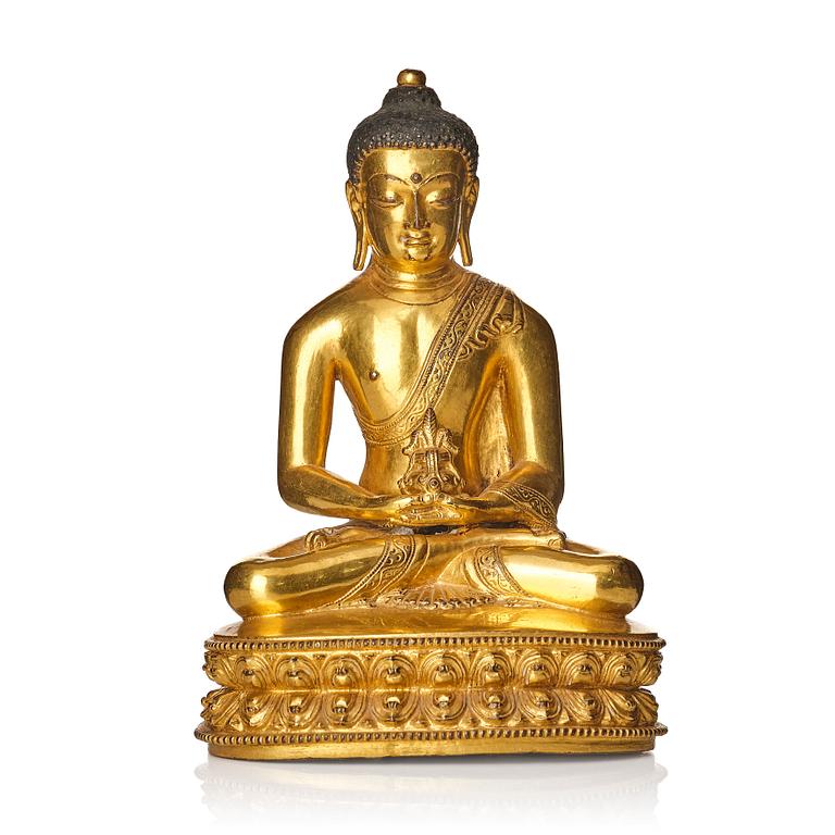 A gilt copper alloy figure of buddha, Tibeto Nepalese, stylistically from the 14th/15th Century,