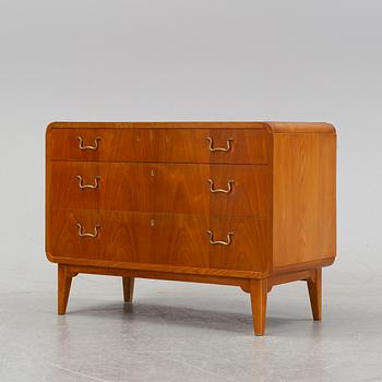 An elm wood venered chest of drawers mid 20th century.