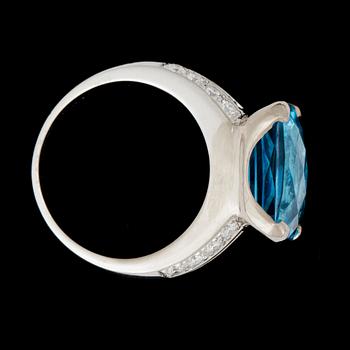 A topaz, circa 16 cts, and diamond, total gem weight circa 0.60 ct, ring.