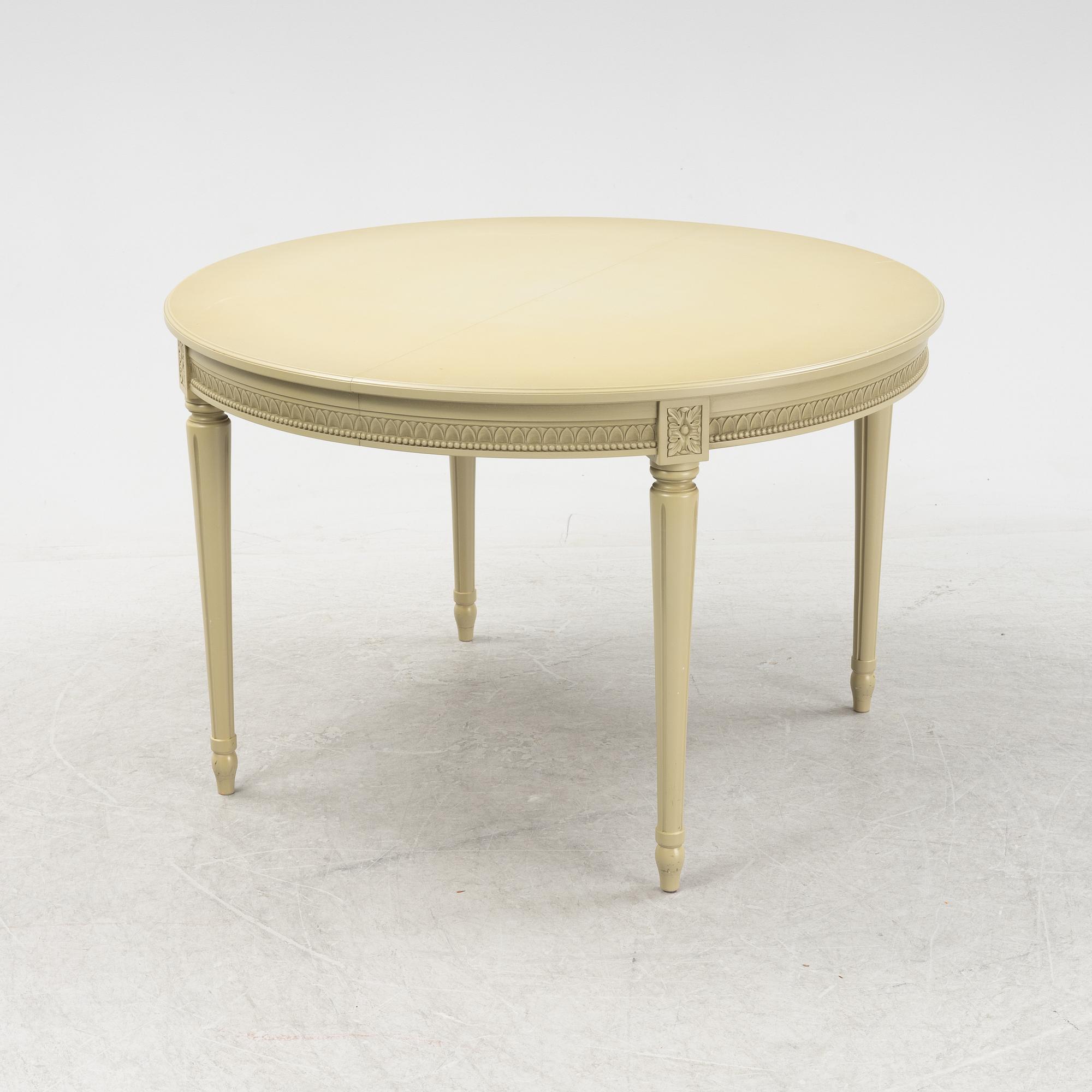 A Gustavian dining table with six chairs. Åmells dated 1974.