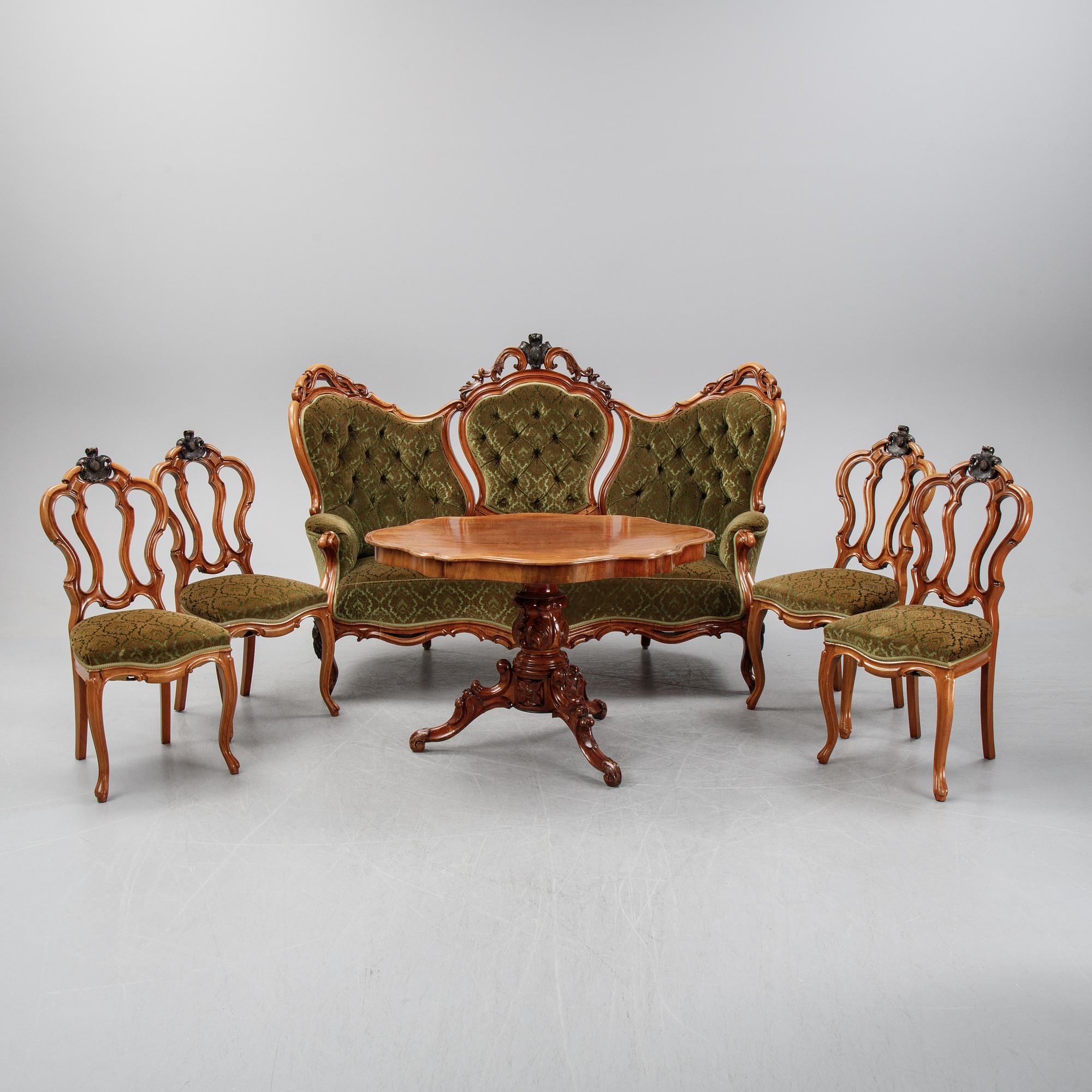 A rococo style sofa, four chairs and a table, second half of the 19th Century.