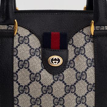 Gucci, a monogram canvas bag.