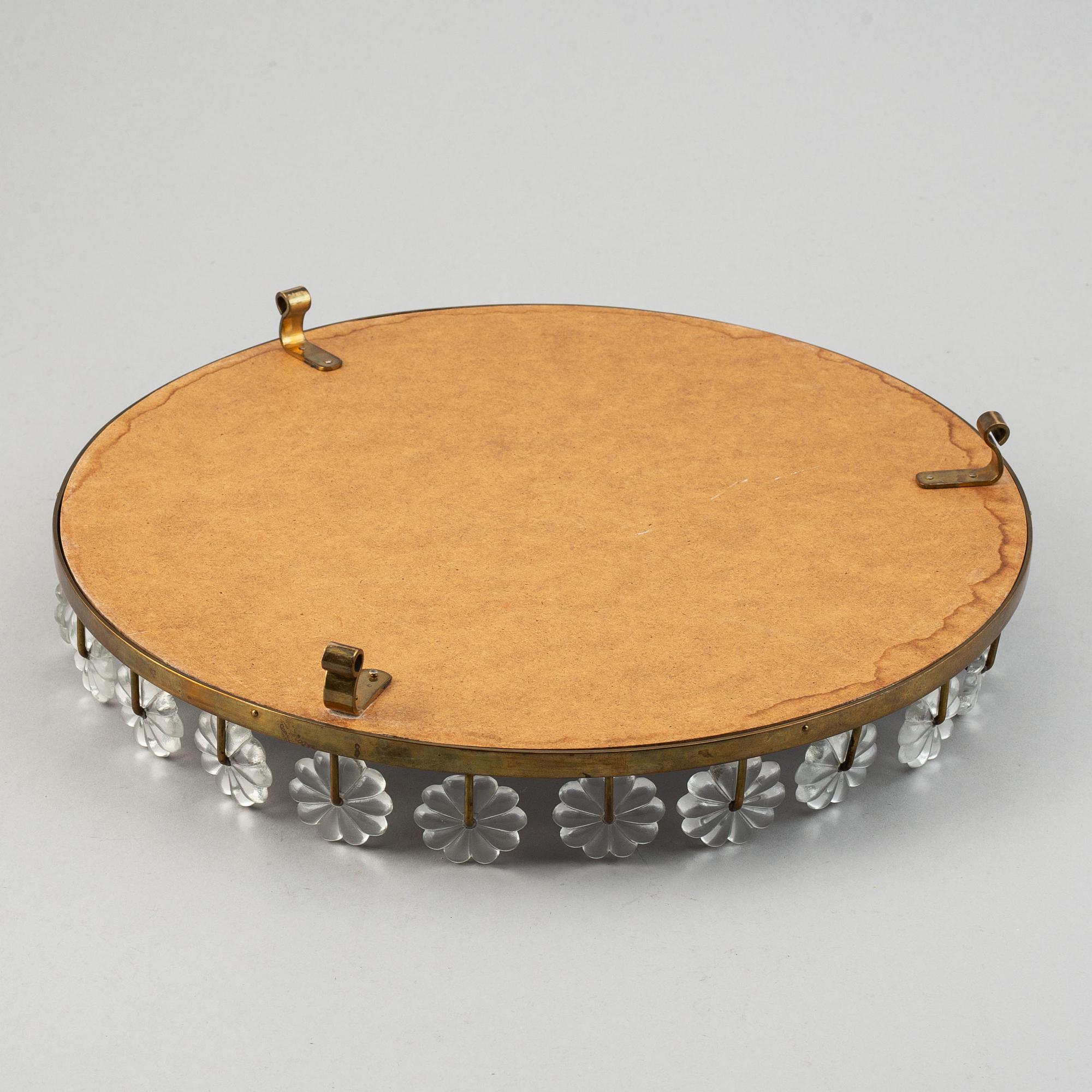 Estrid Ericson,  a mirror and brass table centrepiece from Svenskt Tenn.