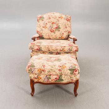 A Louis XV-style armchair and footstool later part of the 20th century.