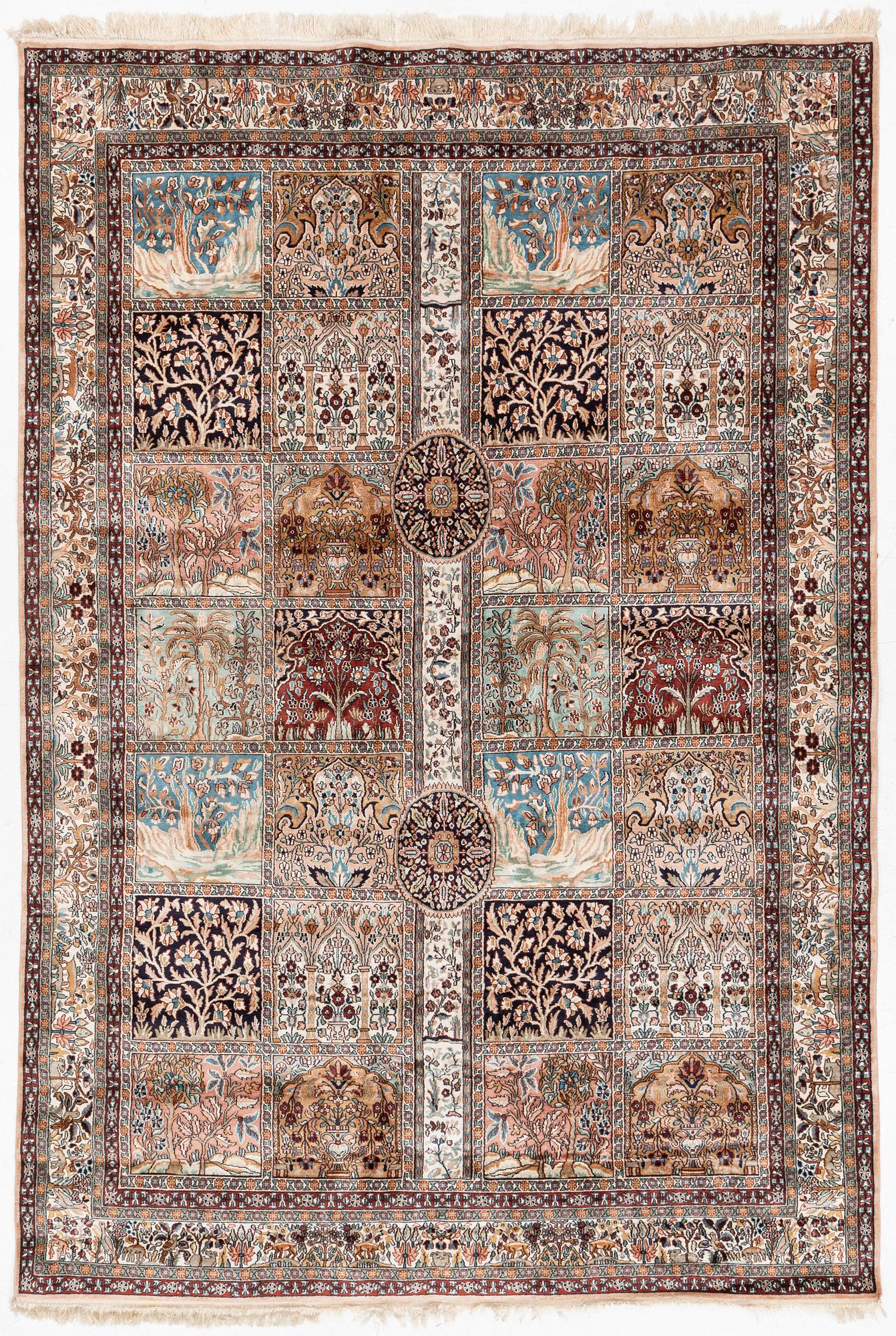An oriental silk carpet, c. 305 x 205 cm.