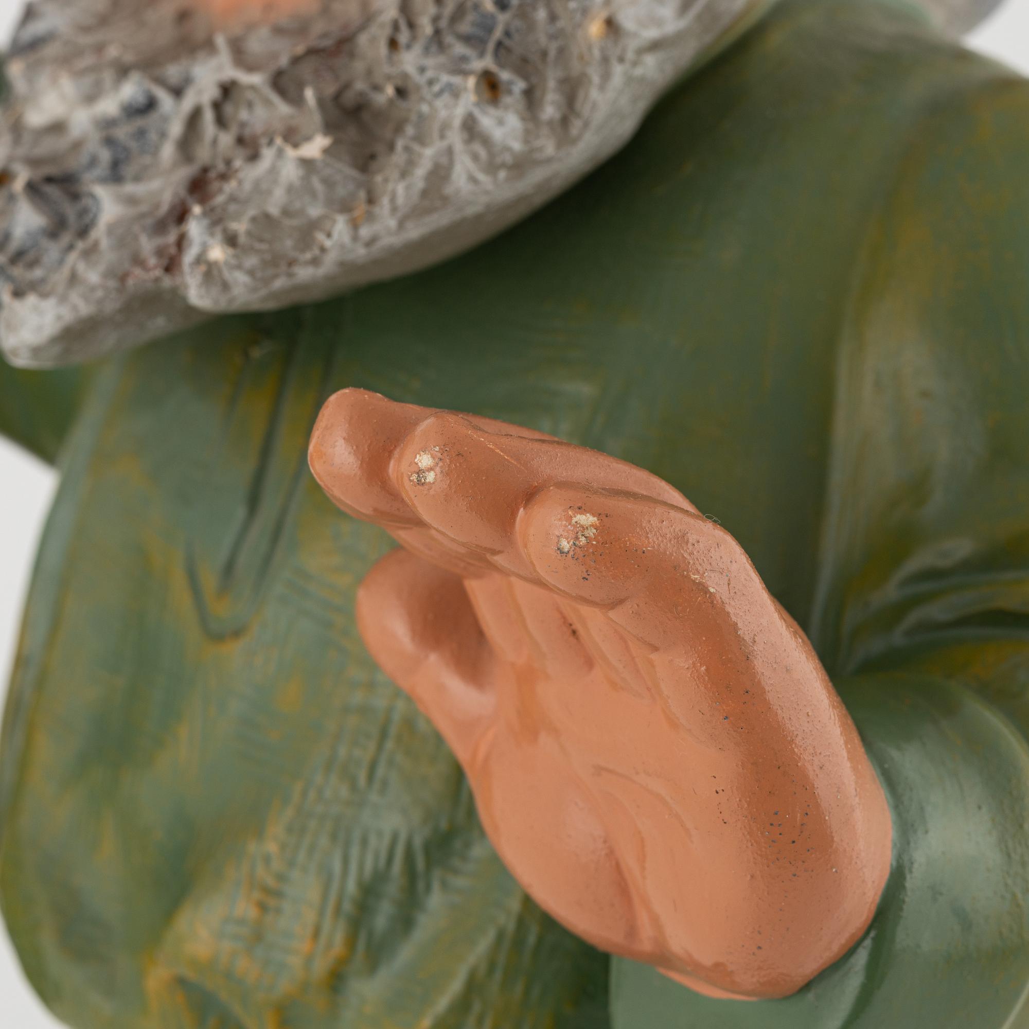 A West German earthenware gnome figurine with lantern from the second half of the 20th century.