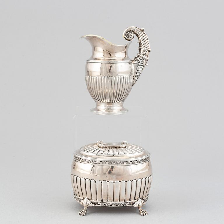 A silver creamer by Johan Petter Ahlforss, Strängnäs, 1833 and a silver sugar box, Kristianstad, 1928.