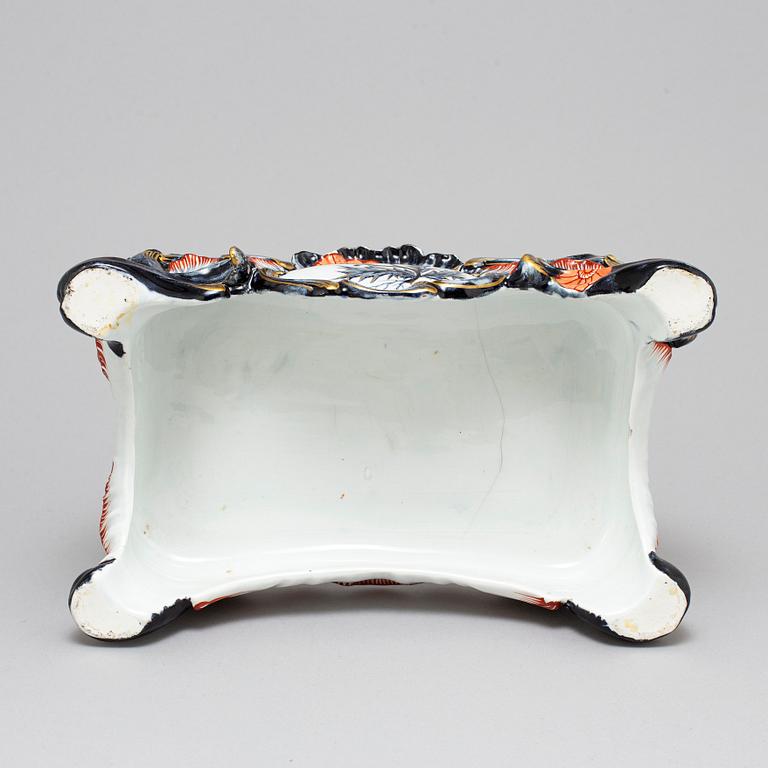 A new rococo creamware bracket clock, after Meissen model, early 20th century.