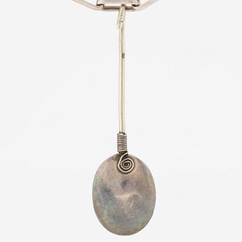 Pendant with silver chain and blue stone, likely moonstone.