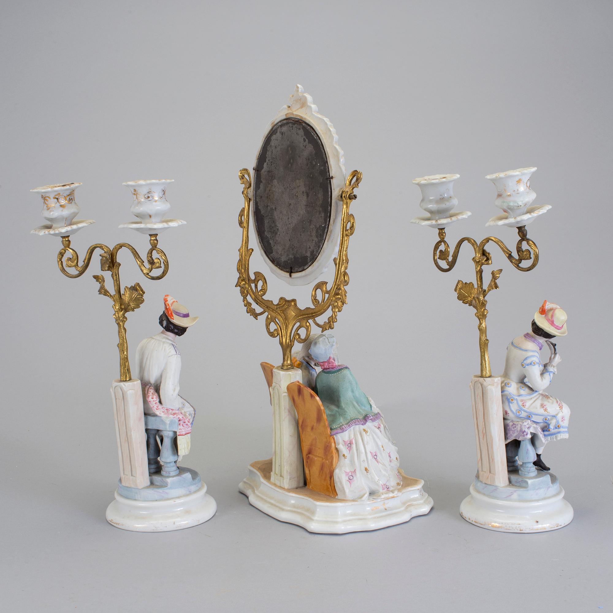 A late 18th century porcelain and biscuit toilette mirror and pair of candelabrar.