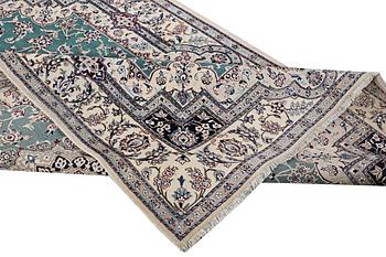 A Nain carpet, part silk, 9 laa, c. 300 x 201 cm.