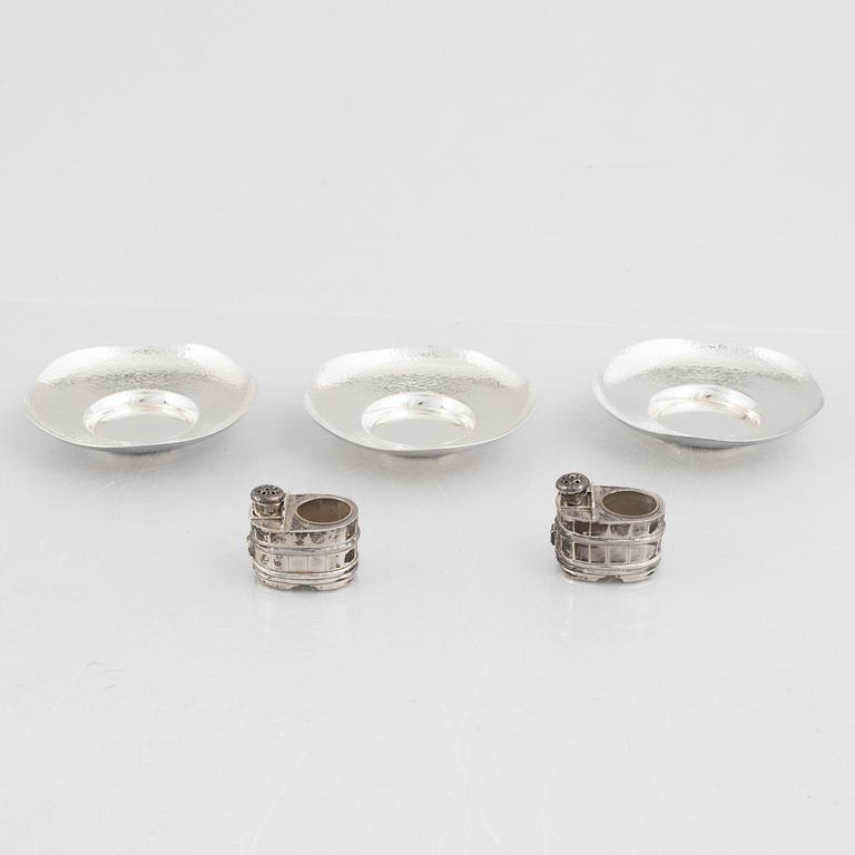 A set of three Japanese silver coasters and a pair of salts with shakers, 20th century.