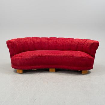 A 1930s curved sofa by Greta Magnusson Grossman for Firma Studio.