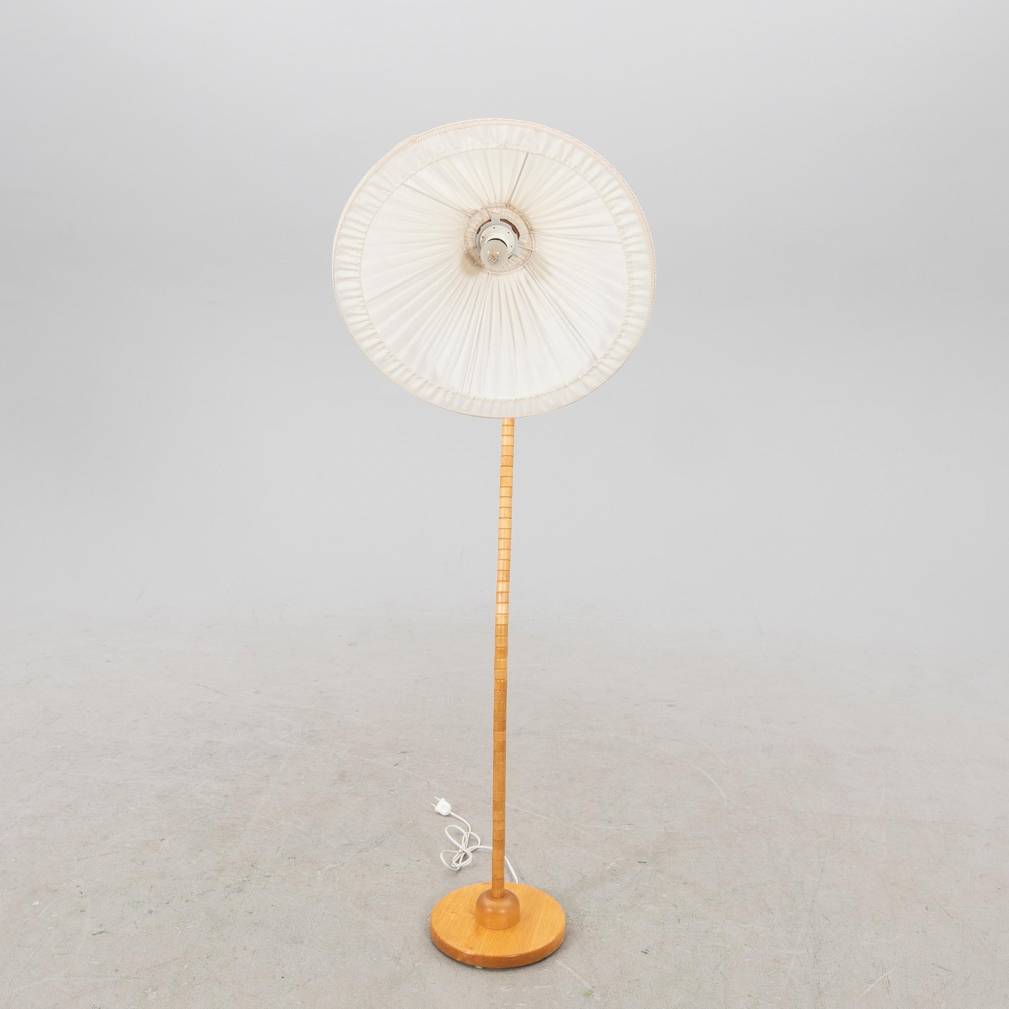 A Markslöjd 21st century wooden floor lamp.