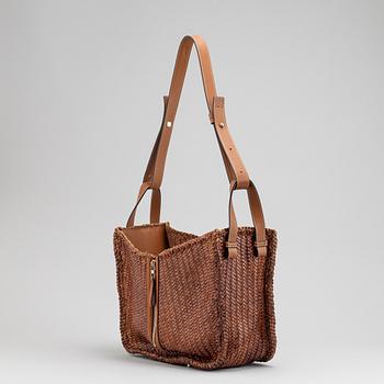 Loewe, a brown woven leather handbag.